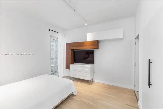 a bedroom with a bed and a couch