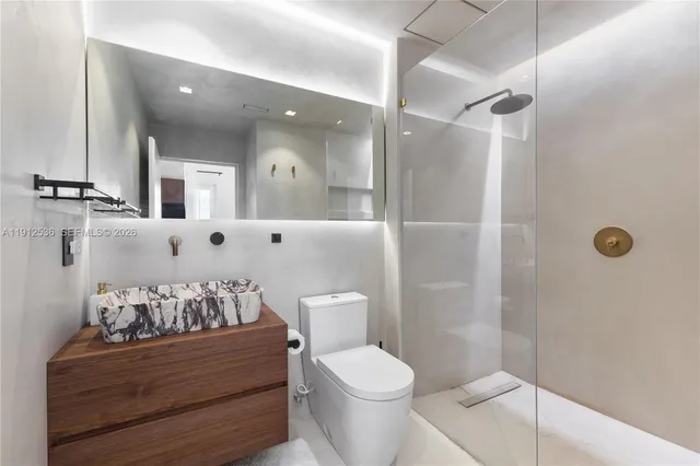 a bathroom with a toilet sink and shower