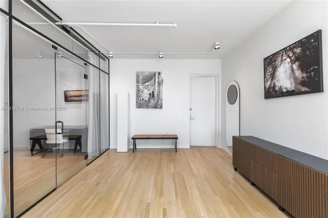 a view of a hallway with wooden floor and furniture