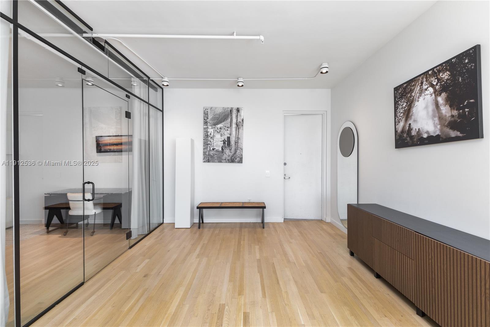 1700 Meridian Avenue, Unit 406 Miami Beach, FL 33139 - Photo 2 of 39 a view of a hallway with wooden floor and furniture