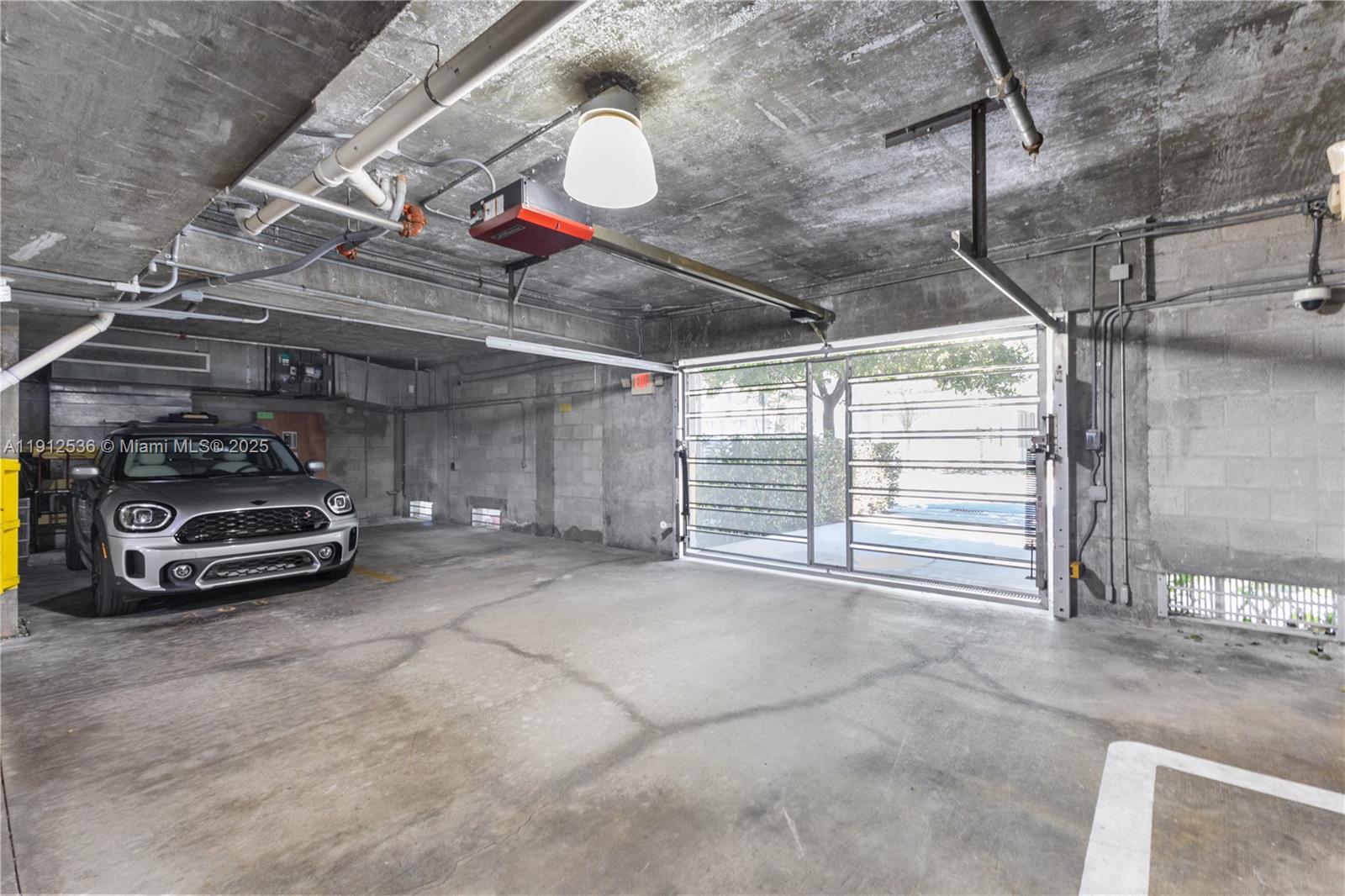 1700 Meridian Avenue, Unit 406 Miami Beach, FL 33139 - Photo 29 of 39 a view of parking garage with cars parked