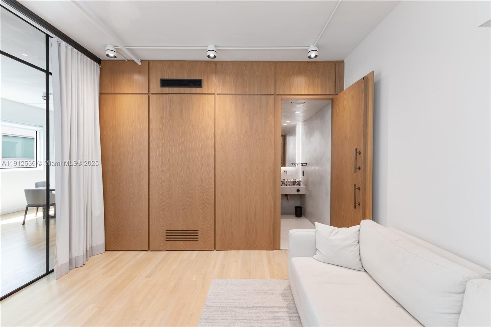 1700 Meridian Avenue, Unit 406 Miami Beach, FL 33139 - Photo 5 of 39 a bedroom with a bed and a glass door