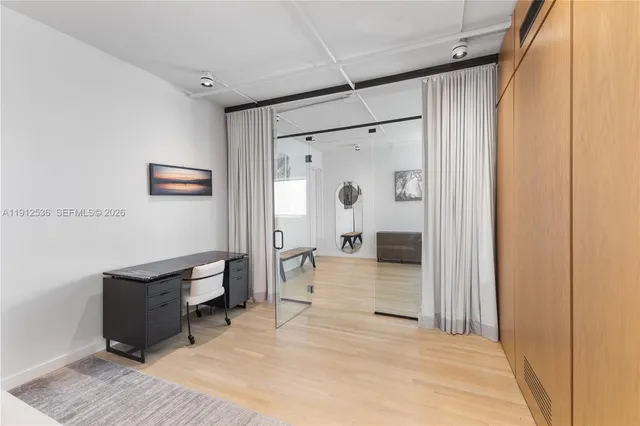 a spacious bedroom with a bed and a shower