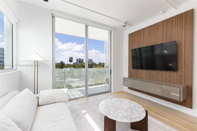 a living room with a large window and a flat screen tv