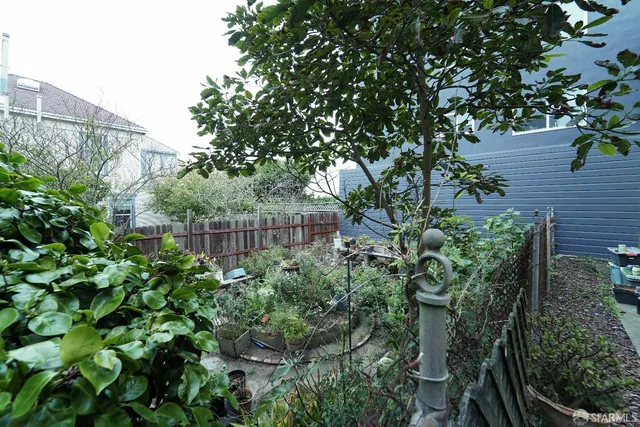 an aerial view of residential houses with outdoor space and parking