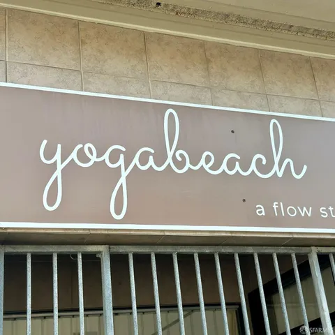 a front view of multi story residential apartment building with retail shops