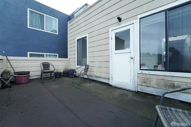a view of a backyard with sitting area
