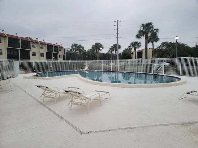 a view of swimming pool with a yard and seating