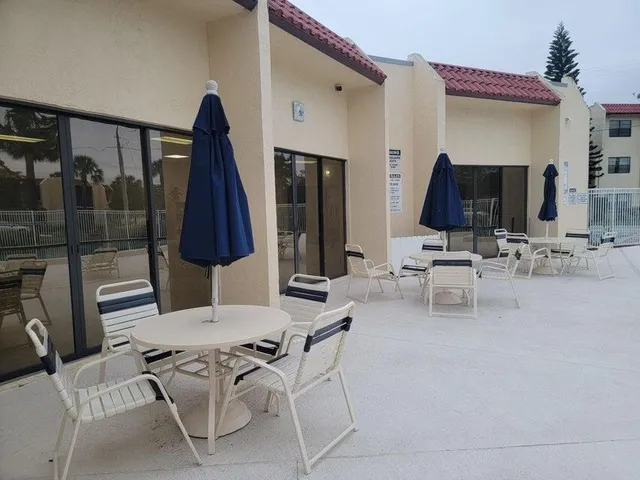 a living room with furniture a flat screen tv and a large mirror