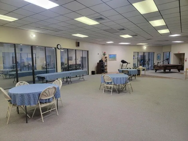 a living room with furniture a flat screen tv and a table