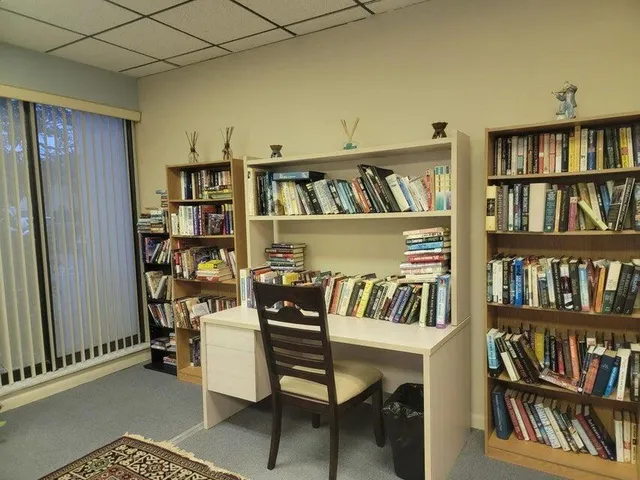 a view of a workspace with bookshelf