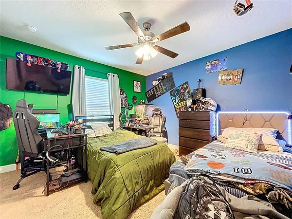 a bed sitting in a bedroom next to a window