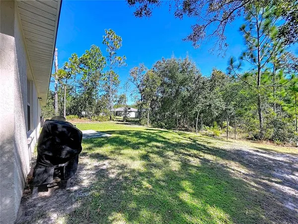 a front view of a house with a yard and potted plants
