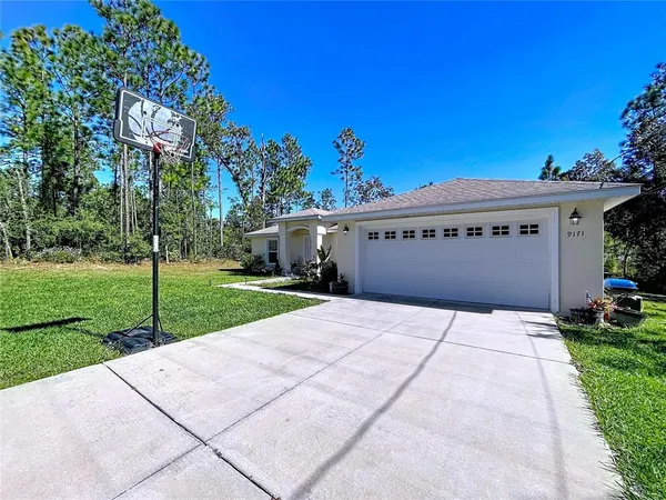 a front view of a house with a yard and garage
