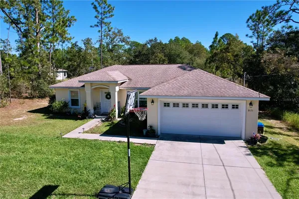 a view of a house with garden and yard