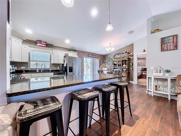a dining table chairs and view kitchen