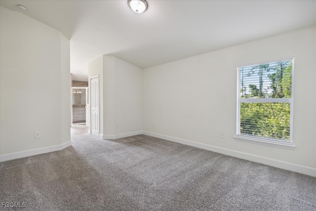 2914 Flora Avenue North Lehigh Acres, FL 33971 - Photo 14 of 39 an empty room with windows and closet