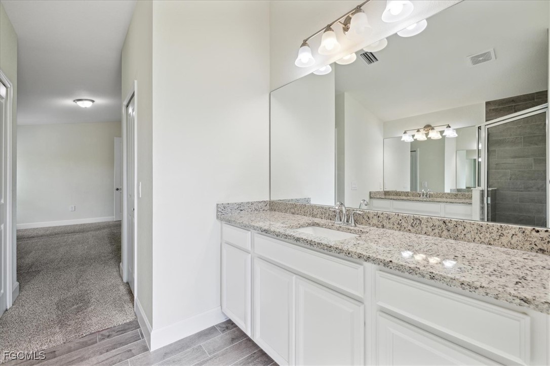 2914 Flora Avenue North Lehigh Acres, FL 33971 - Photo 16 of 39 a bathroom with a sink and a mirror