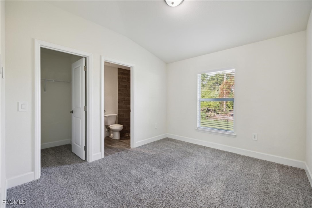 2914 Flora Avenue North Lehigh Acres, FL 33971 - Photo 18 of 39 an empty room with windows and closet