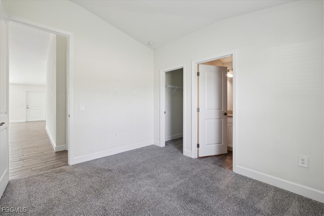 2914 Flora Avenue North Lehigh Acres, FL 33971 - Photo 19 of 39 an empty room with closet and wooden floor