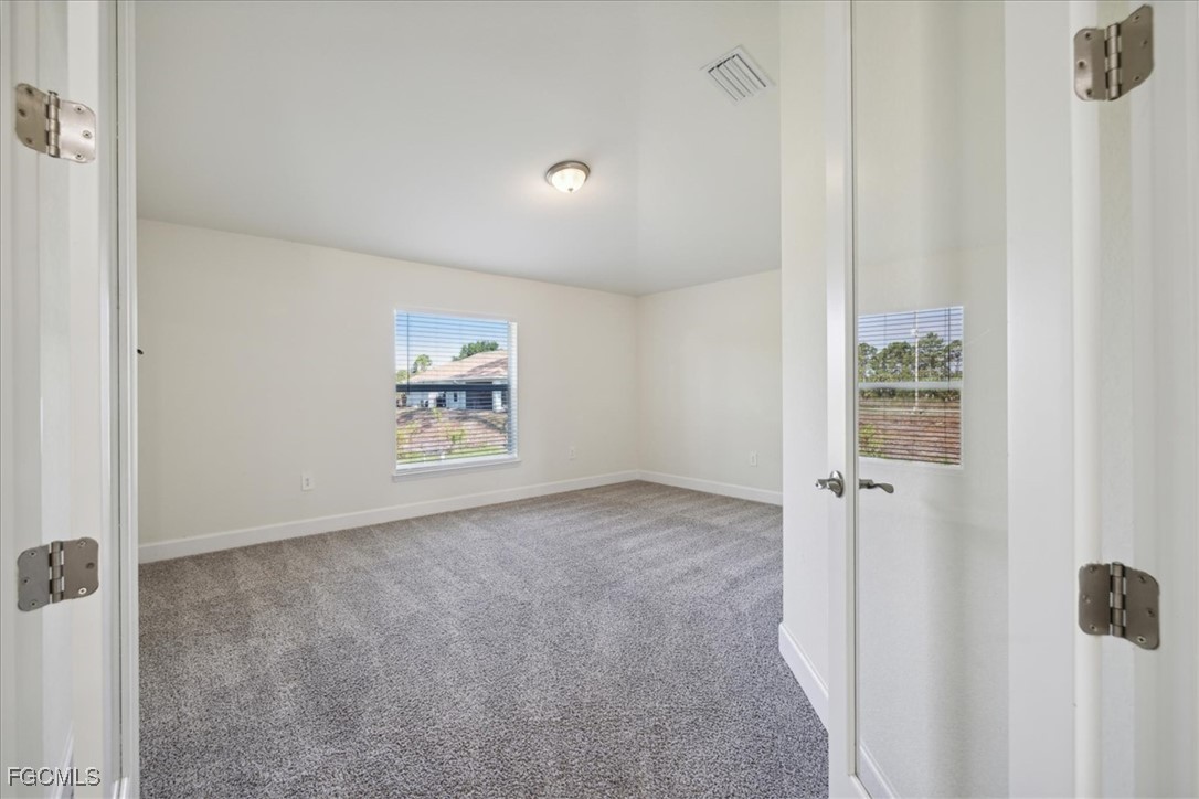 2914 Flora Avenue North Lehigh Acres, FL 33971 - Photo 21 of 39 a view of an empty room with a window
