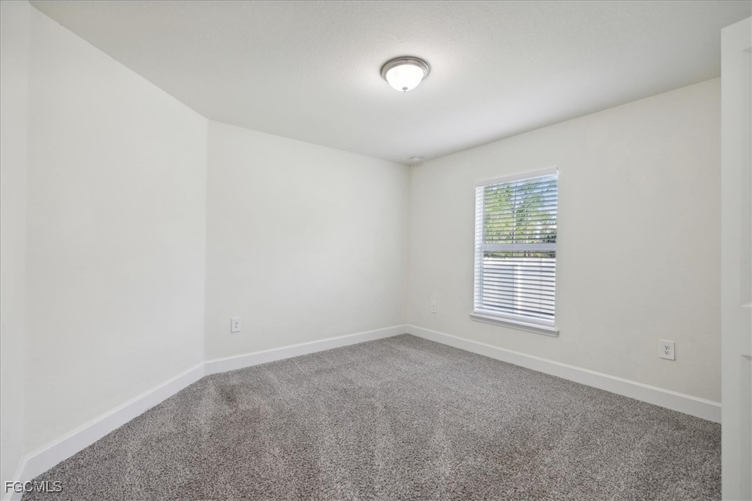 2914 Flora Avenue North Lehigh Acres, FL 33971 - Photo 23 of 39 an empty room with a window