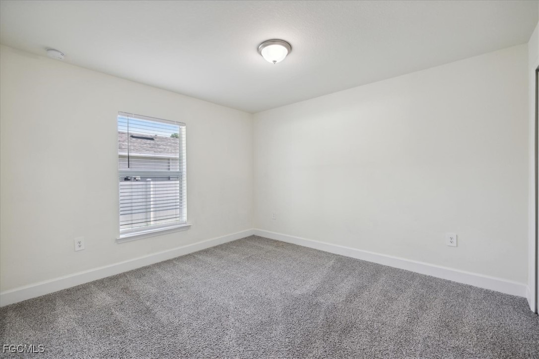 2914 Flora Avenue North Lehigh Acres, FL 33971 - Photo 26 of 39 a view of an empty room with a window