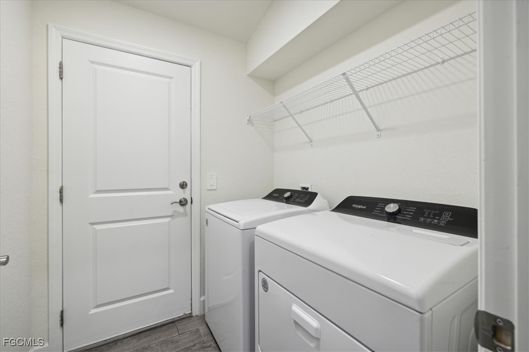 2914 Flora Avenue North Lehigh Acres, FL 33971 - Photo 28 of 39 a utility room with dryer and washer