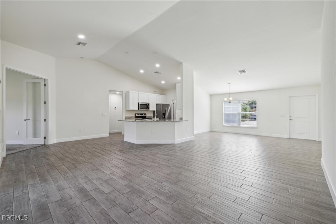 2914 Flora Avenue North Lehigh Acres, FL 33971 - Photo 8 of 39 a view of kitchen and hall with wooden floor