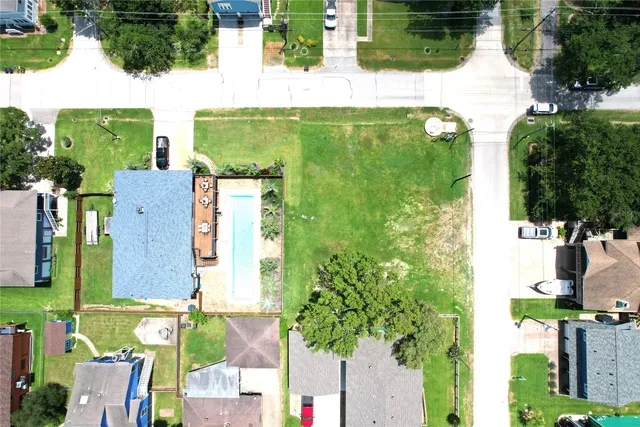 an aerial view of a house with a garden and swimming pool