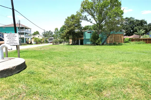 a front view of a house with a garden and trees