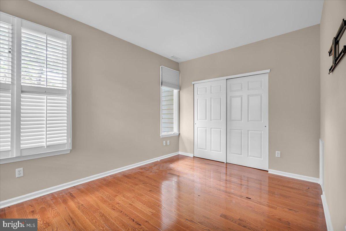 5 Promenade Place Voorhees, NJ 08043 - Photo 19 of 24 a view of an empty room with wooden floor and a window