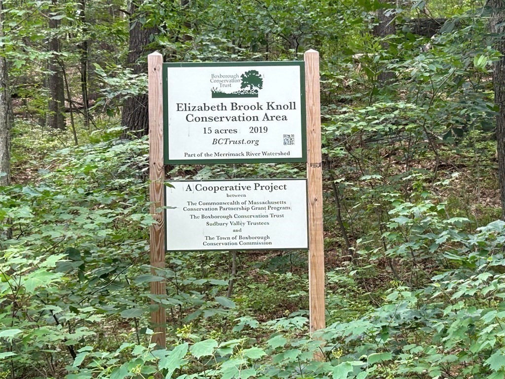 196 Swanson Road, Unit 510 Boxborough, MA 01719 - Photo 15 of 20 a sign broad on the side of the tree