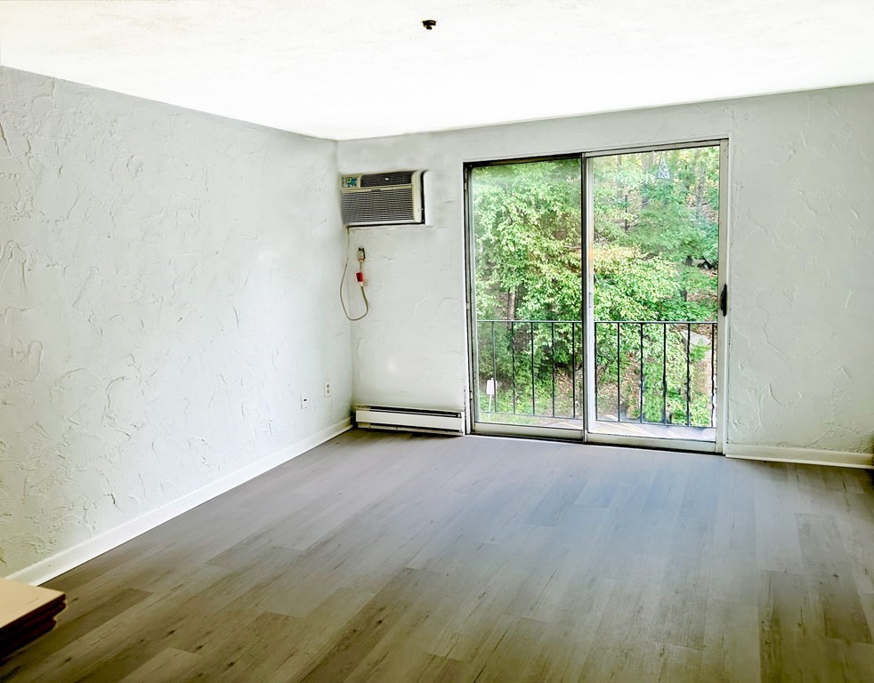 196 Swanson Road, Unit 510 Boxborough, MA 01719 - Photo 4 of 20 a view of a room with wooden floor and windows