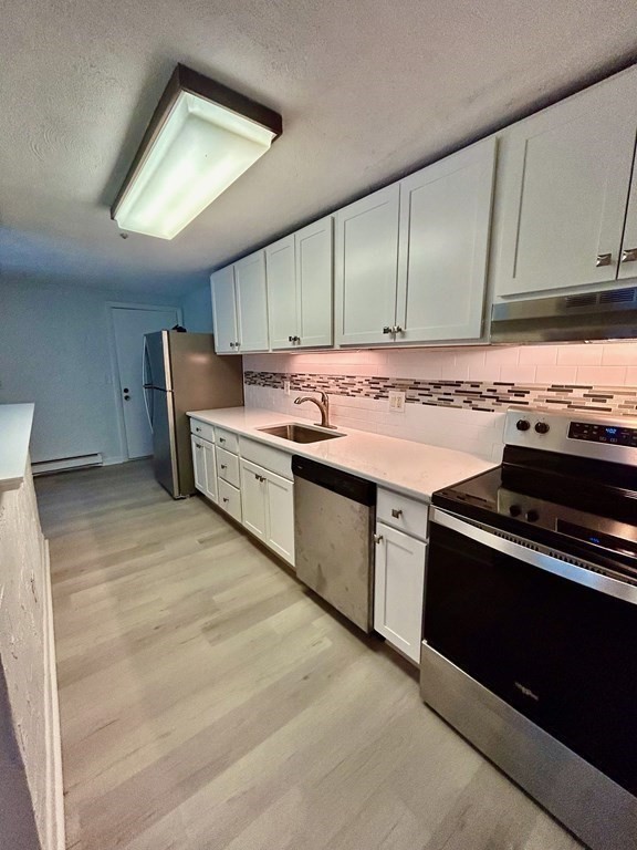 196 Swanson Road, Unit 510 Boxborough, MA 01719 - Photo 6 of 20 a kitchen with a stove and a sink