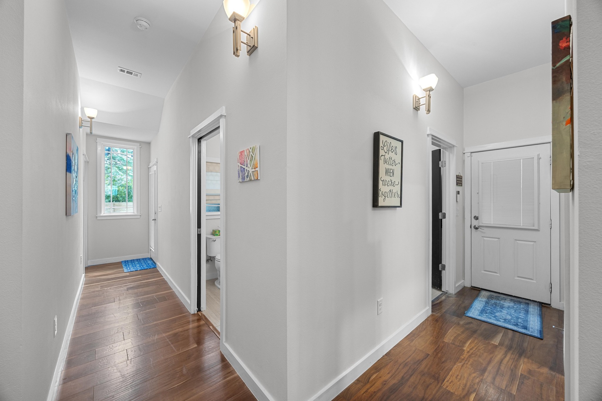 3907 Becker Avenue Austin, TX 78751 - Photo 13 of 37 Hallway featuring wood floors, baseboards and high ceilings.