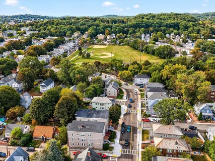 an aerial view of residential houses with outdoor space