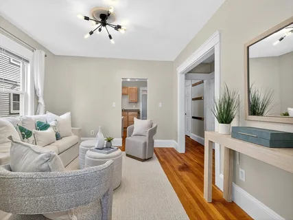 a living room with furniture and a chandelier