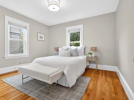 a bed room with a bed and a chair