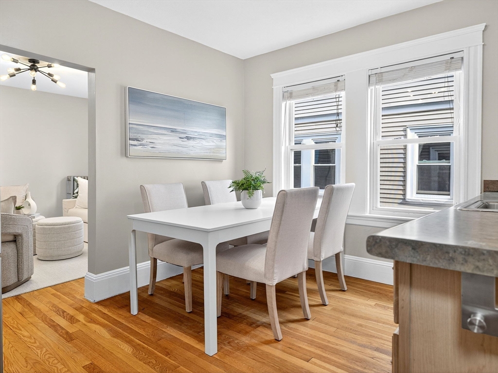 187 Florence Street, Unit 2L Boston, MA 02131 - Photo 6 of 15 a view of a dining room with furniture window and wooden floor