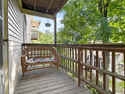 a view of a balcony with wooden floor