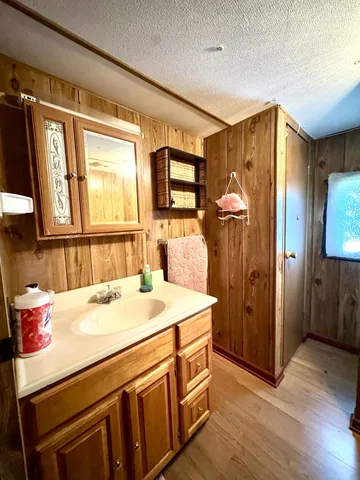 a bed sitting in a spacious bedroom next to a bathroom