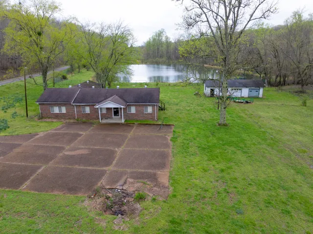a view of a lake with a house in the background