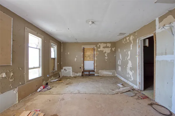a view of an empty room with glass door