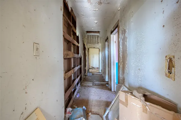 a view of hallway with stairs and wooden floor