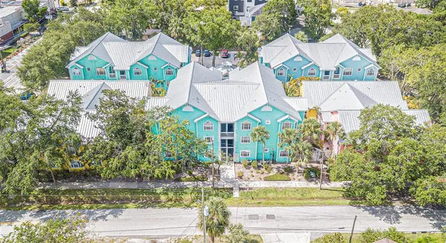 a aerial view of a house with a yard and lake view