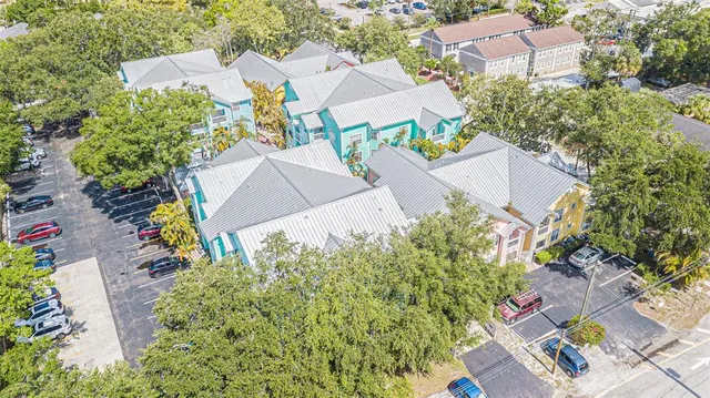 an aerial view of a house with a yard and garden
