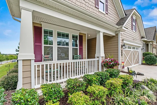 a view of a hallway with wooden floor and furniture