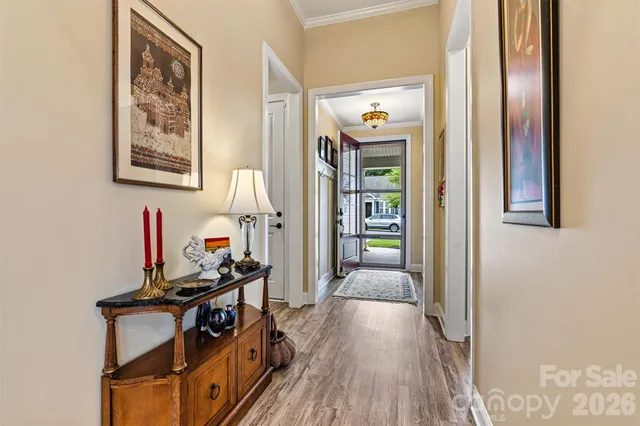 a living room with furniture fireplace and large windows
