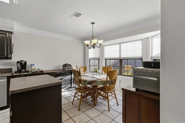 a view of a dining room with furniture and a chandelier